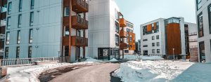 Contemporary apartment complex surrounded by snow, showcasing winter architecture.